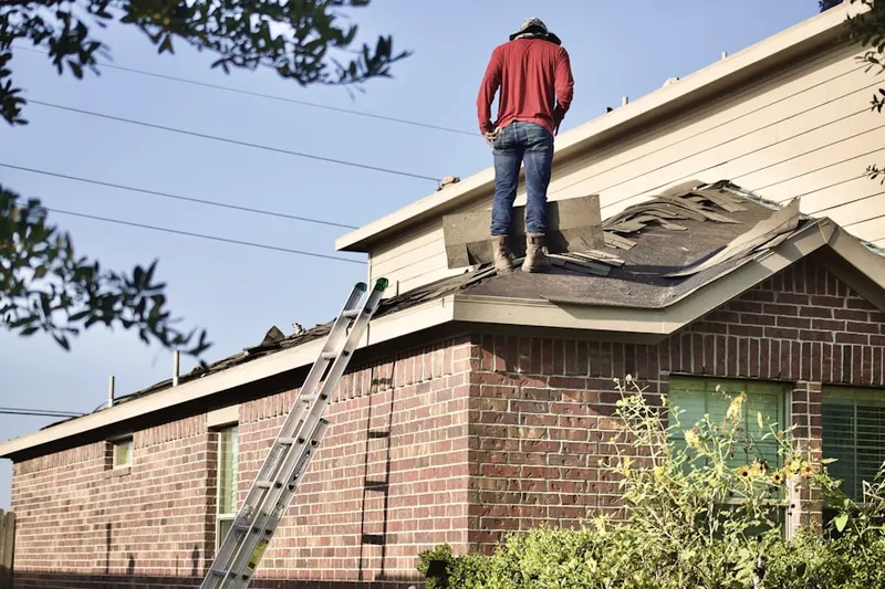 Professional roofer working on a residential roof in Durant